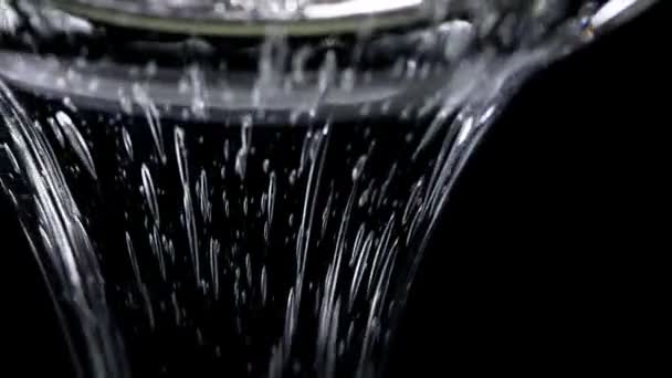 Clear glucose. viscous glucose pours beautifully on a black background. slow motion. — Stock Video