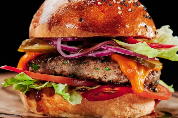 Hamburger di manzo con formaggio, pomodori, cipolle rosse, cetriolo e lattuga Close up. Menù hamburger. Spazio per il testo. Cibo malsano. — Foto Stock