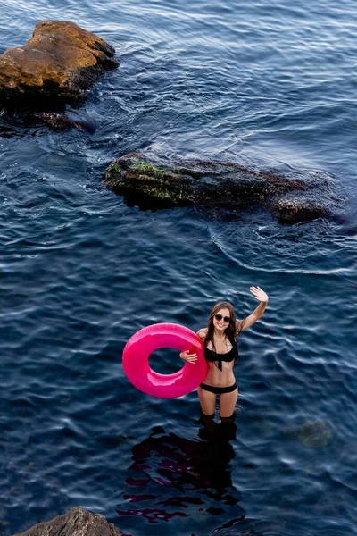 Sexy woman with pink Inflatable swimming circle on the beach. Blue ocean. Girl with swimming ring. Photo Summer vacation. Top view — Photo