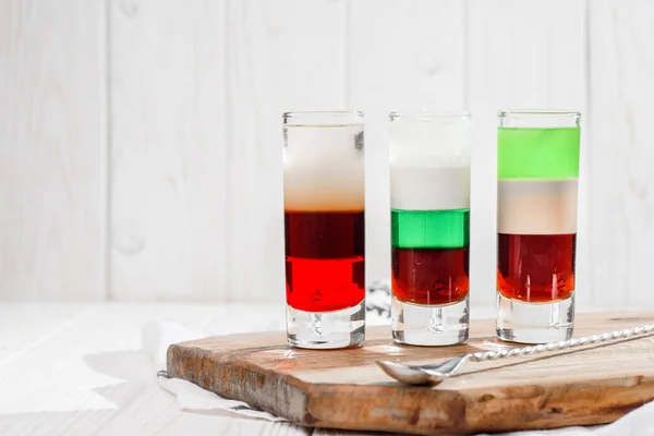 Trzy kolorowe drinki na białym tle. Silne napoje alkoholowe i tequila — Zdjęcie stockowe