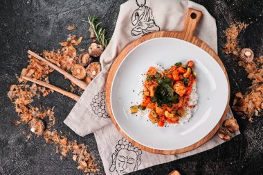 Asian rice with vegetables and fried chicken with curry. Traditional pan asian cuisine. Top view