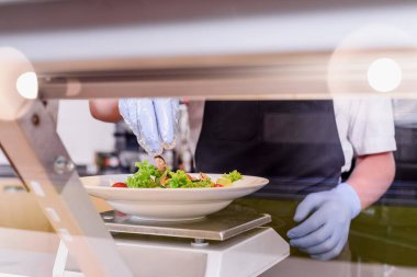 Showcase salad bar with an assortment of ingredients for healthy and dietary food. Salad making process