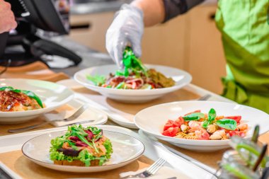 Chef prepares salad at the salad bar. Salad making process
