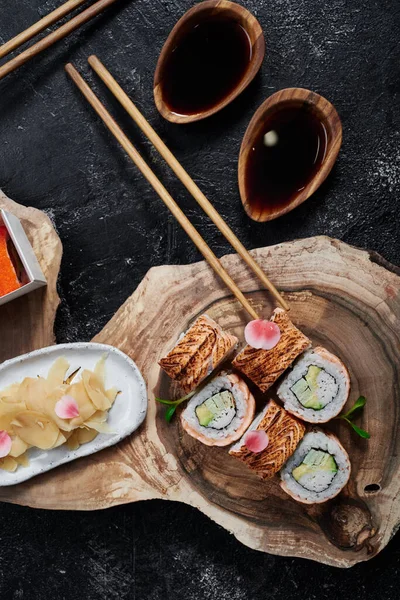 Sushi roll with baked salmon on beautiful wooden cut. Top view. Banner. Space for text. — Photo