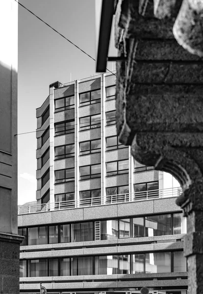 Facade of modern multi-storey building in the city. Black and white vertical photo. — Stock Photo, Image