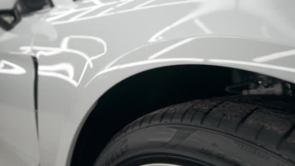 Autovervollständigung. Businessklasse-Autoscheinwerfer mit blauer Beleuchtung auf weißem Auto. Sportwagen — Stockvideo