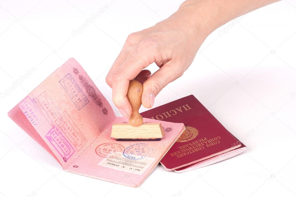 Female hand stamping a passport of the Soviet Union