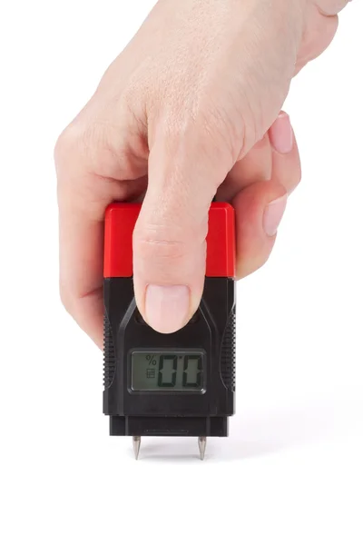 Female hand measuring moisture in wall — Stock Photo, Image