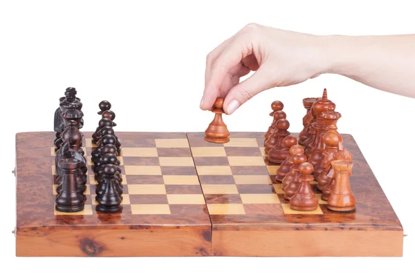 Female hand holding a pawn on the chessboard — Stock Photo, Image