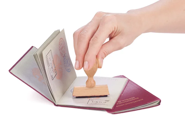 Female hand stamping a passport of Germany — Stock Photo, Image