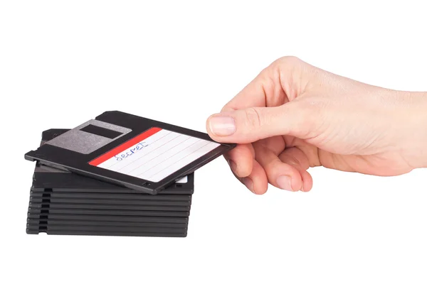 Female hand takes a floppy disk — Stock Photo, Image