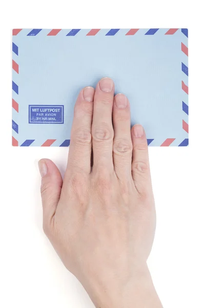 Female hand holding air mail envelope — Stock Photo, Image