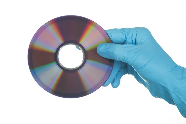 Female Hand in glove with dvd — Stock Photo, Image