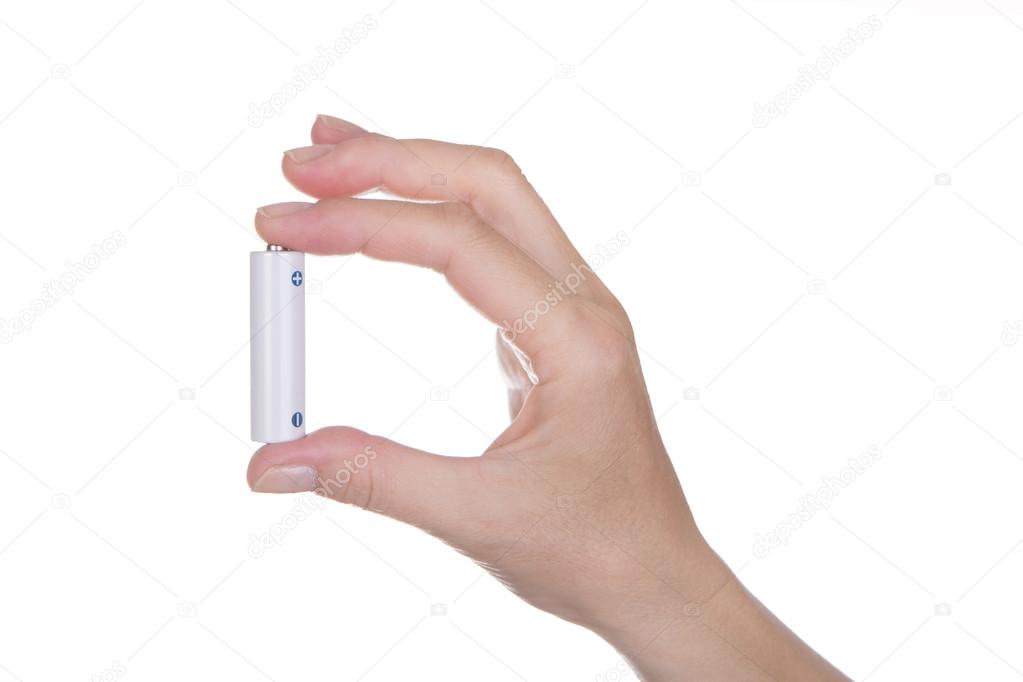 female hand holding a AA battery
