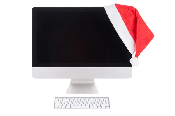 Cappello Babbo Natale rosso sul monitor del computer moderno — Foto Stock