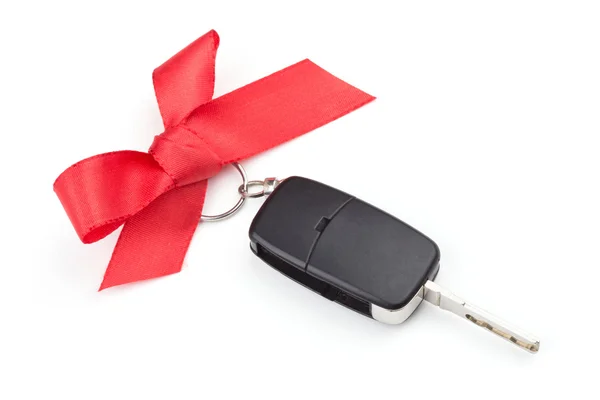 Klíče od auta s červenou stuhu — Stock fotografie