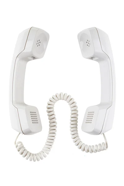 Two telephones receivers connected with a cable — Stock Photo, Image