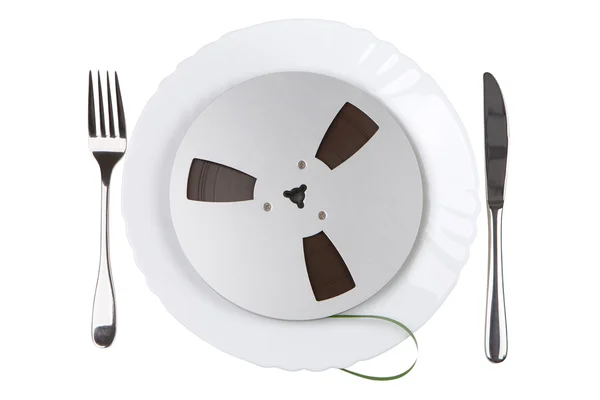 Plate with a tape recording with knife and fork — Stock Photo, Image
