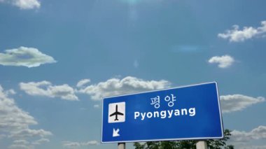 Jet uçağı Pyongyang, Kuzey Kore 'ye iniyor. Havaalanı istikameti işaretli şehir gelişi. Seyahat, iş, turizm ve ulaşım kavramı.