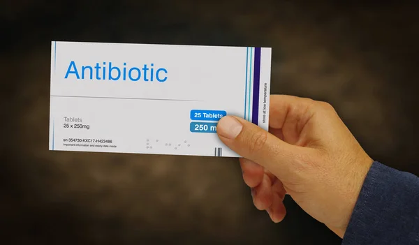 Antibiotic pack in hand. Medical infection therapy drug box. Abstract concept 3d rendering illustration.