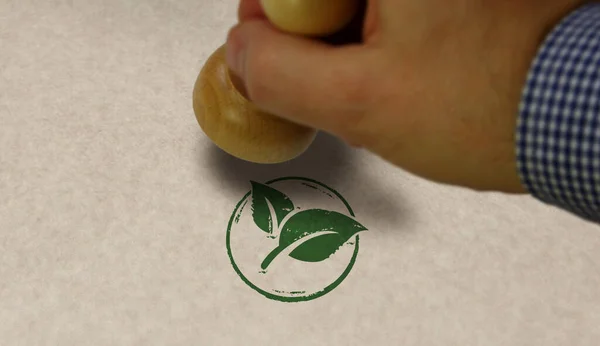 Green leaf eco friendly symbol stamp and stamping hand. Co2 neutral, ecology, environment, nature and climate concept.