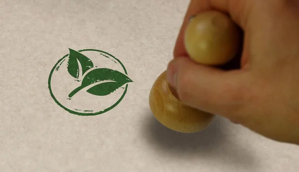 Green leaf eco friendly symbol stamp and stamping hand. Co2 neutral, ecology, environment, nature and climate concept.