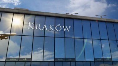Krakow, Cracow, Polonya 'ya iniş yapan bir jet uçağı 3 boyutlu animasyonu canlandırıyor. Cam havaalanı terminali ve uçağın yansıması ile şehre varış. Seyahat, iş, turizm ve ulaşım kavramı.
