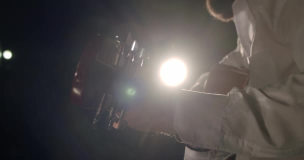 Male hands play acoustic guitar in rays of light. Close-up. V4 — Stock Video