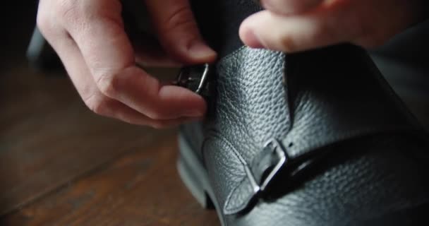 Mens hands fastens black shoes formal and festive attire. Close up — Stock Video