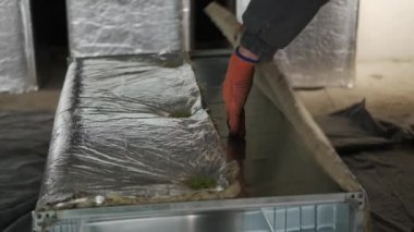 Tanınmayan, çalışan iki hava ısıtma sistemi kuruyor. Fırın ve Merkezi Isıtma Pompası Kanalı kuruluyor. Isıtma ve soğutma işi. Kapat.