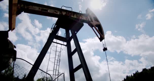 Oil Field Pump Jack tegen Blue Sky en wolken. Langzame beweging Breed schot — Stockvideo