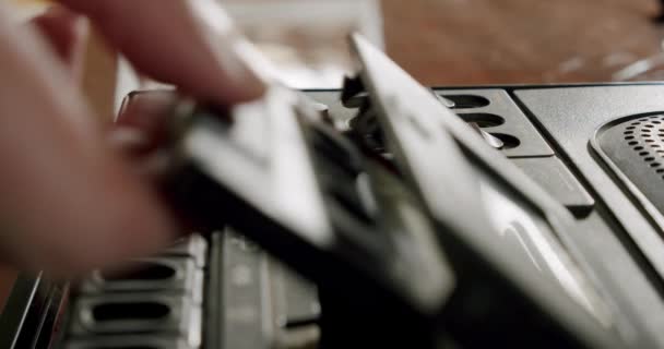 Male hands insert an audio cassette into a retro tape recorder. Close up — Stock Video