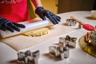 Womans hands roll the dough. Protection Symbol, heat comfort. V4