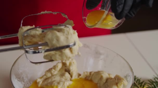 Cose up view A raw egg falls into the dough, Baker cooking dough baking cake Slow motion Version 2 — Stockvideo