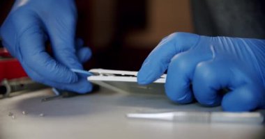 Elektronik tamir servisindeki tamirci özel aletlerle telefonu tamir için açar ve kapatır.