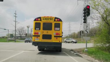 Okul otobüsü yola çıkar ve kavşaktan döner.