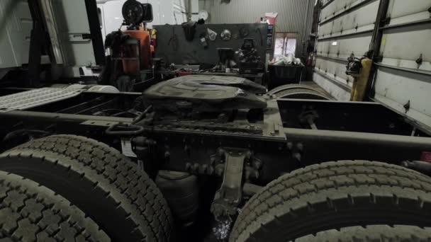 Truck reparatiewerkplaats, de camera beweegt van de gedemonteerde truck naar het midden van de winkel. Slow Move-camera — Stockvideo