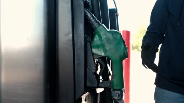 Feche a mão de homem que põe um bocal de combustível verde. Gasolina, conceito de posto de gasolina Estação de camionagem — Vídeo de Stock