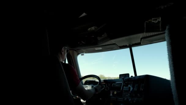 Wide shot of Truck driver rides to destination cargo . Man driving truck at road on summer day. Slow motion futage — Stockvideo