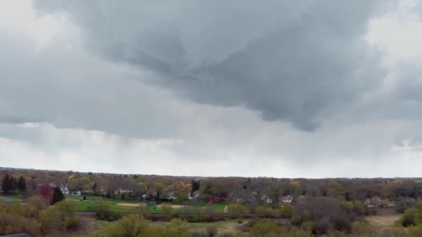 Drone aerial view. Thunderstorm rain clouds and sunset at countryside with village and meadows — Stock Video