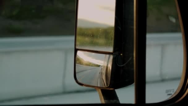 Truck driver rides to destination cargo at road on day in the suns rays. Slow motion Close up shot. — Stock Video