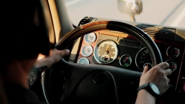 Truck driver rides to destination cargo . Driving truck at road on warm summer day and speaks to the expediter or client through a professional headset. Close up — Stock Video