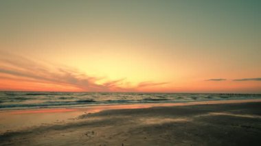 Dramatik deniz gündoğumunun geniş açılı görüntüsü. Yavaş çekim yanan gökyüzü ve parlayan altın dalgalar.