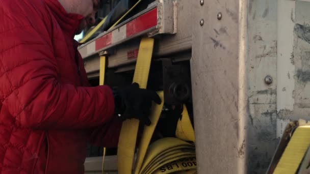 Close up futage of Cargo shipping. Men workers fasten the load on the truck. — Stock Video