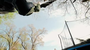 Boy having fun on chain swing on playground. swing Kids play outdoor. Down view