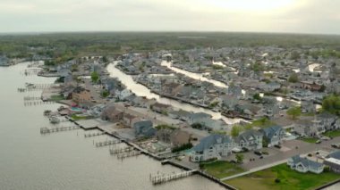 Aerial drone view of local residential suburb of river in view of distant Toms River. USA