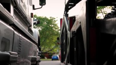 Close up view of tyres of trucks stand in the parking lot. Rear shot, move camera
