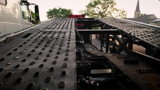 Trucks with a car hauler stand in the parking lot. close up Rear close up shot — Vídeos de Stock