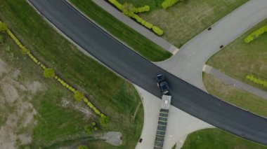 Aerial drone view of Truck rides on road that turns. Top view futaeg