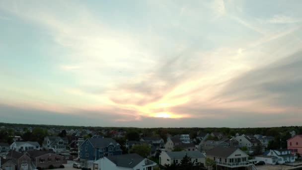 Above Aerial drone. Local residential suburb of river in view of distant Toms River. — Stock Video